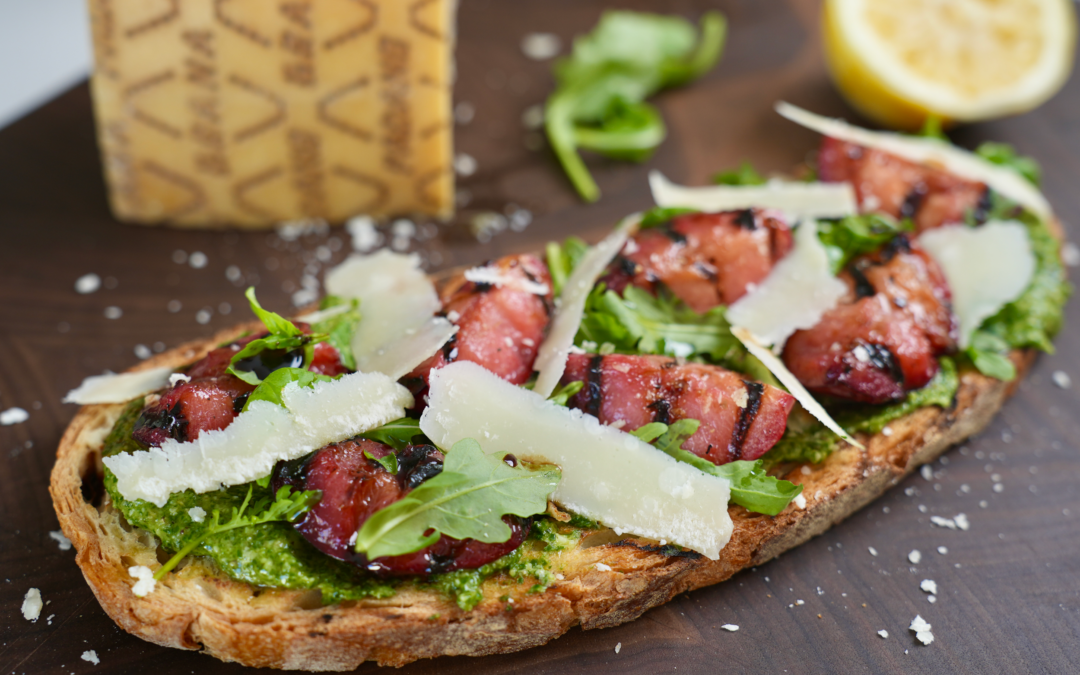 Bruschetta with plums, green sauce and Grana Padano PDO